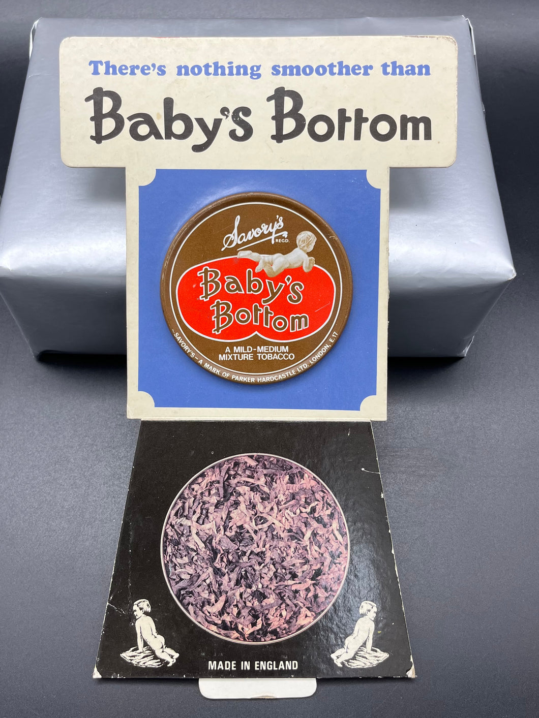 Baby’s Bottom Tobacco Cardboard Counter Advertisement with Tin Display